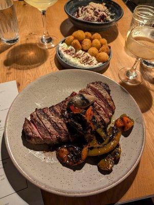 New York Strip. $49. Jimmy Nardello peperonata, crispy potatoes, black garlic + shoyu butter.