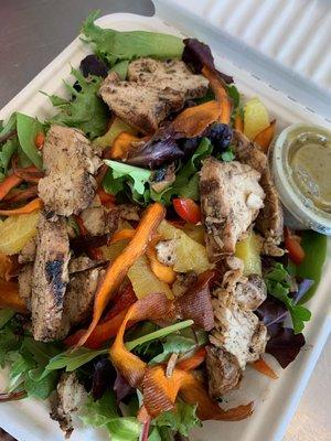 Mixed Green Salad with grilled chicken, carrot ribbons, oranges, cumin lime dressing