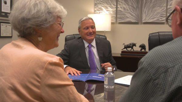 Bryan Gaiser meeting with senior clients in his retirement planning office.