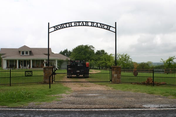 Iron automatic swing gate with custom frame.