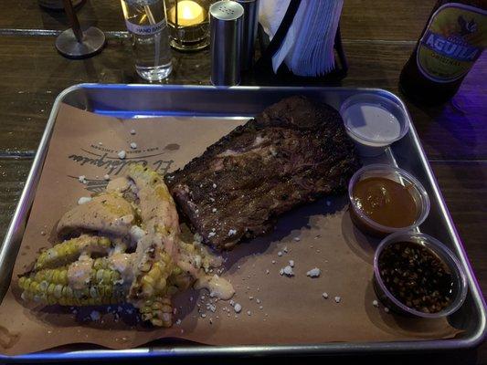 Half a rack of baby back ribs with a side of corn ribs