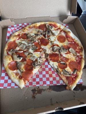 Medium red pizza with pepperoni and mushrooms thin and crispy. Sorry, missing one slice. I couldn't wait!