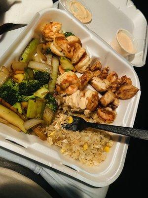 chicken and shrimp with fried rice and veggies.