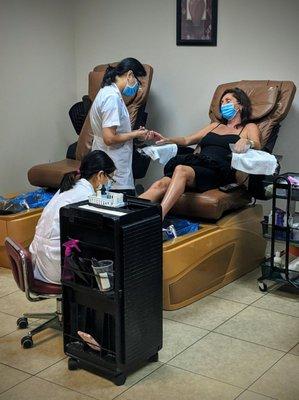 A customer receiving both a mani and pedi simultaneously!