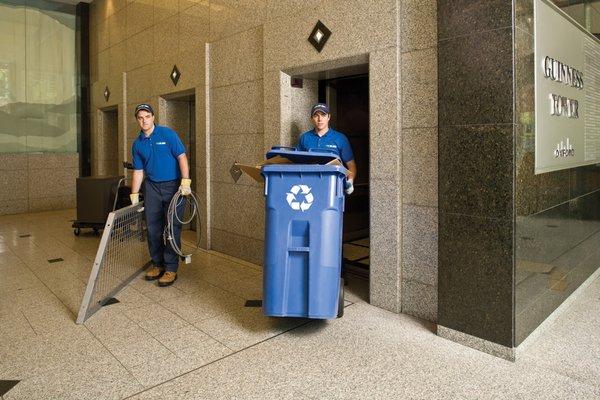 1-800-GOT-JUNK? team taking out the dumpsters