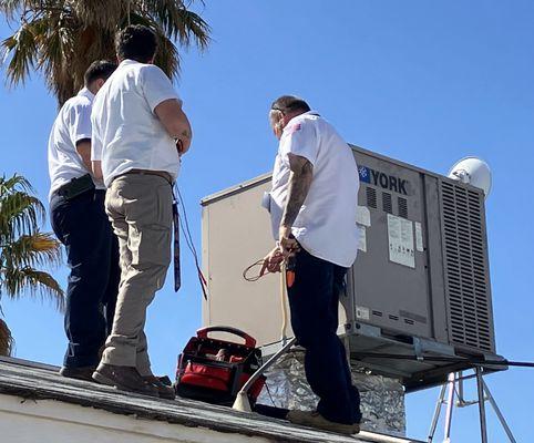 Initial assessment of the AC unit on the roof, led by Sean.