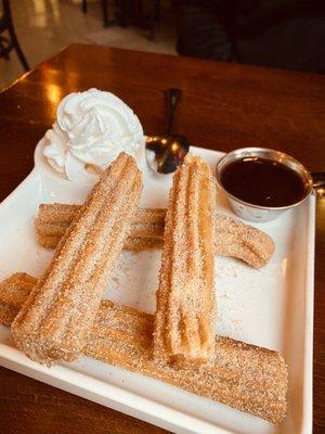 Churros with chocolate sauce and vanilla ice cream