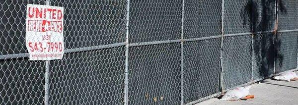 Temporary construction fencing panels with mesh screen installed in less than 24 hours by United rent a fence.