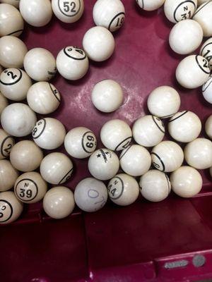 Unprofessional bingo balls many hand written on and faded