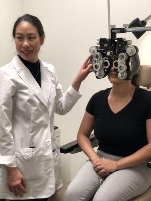 Dr. Nudta carefully measuring a patient's glasses prescription!