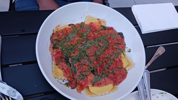 Mezzaluna Ravioli w/ tomato basil & pesto cream sauce.