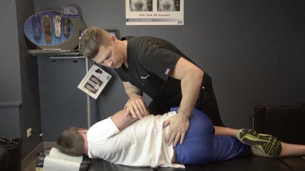 Dr. Tavenner delivering a pain relieving lower back adjustment.