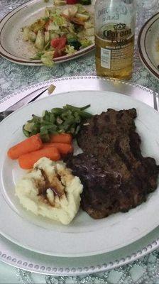 Hard mashed potatoes, canned vegetables, and a sorry excuse of a "12 ounce ribeye"