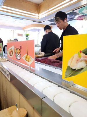 Sushi chefs cutting a big Tuna fish