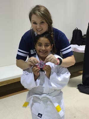 Sensei Jessica and student Alexandra after winning a medal.