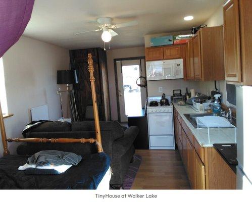 White stove fits well in 200sq foot tiny house