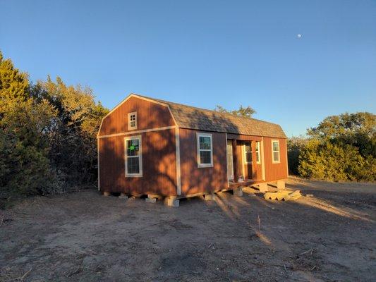 The finished "shed" (aka our cabin shell).  We customized a fair amount (added lots of windows, a little porch, extended loft)