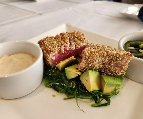 Sesame crusted seared wild caught Ahi tuna steak over fresh avocado & seaweed salad, with jalapeno soy sauce and chili aioli.