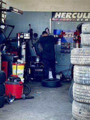 Worker replacing the tire on the rim