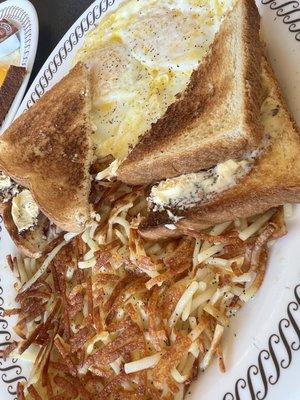 Over easy eggs, hash browns, white toast, ham and a waffle on the side