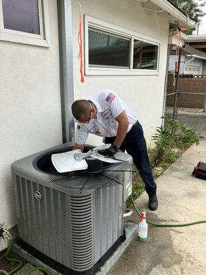 Juan cleaning out the A/C