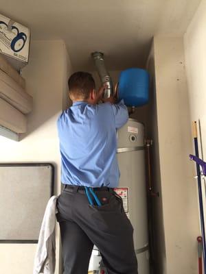 One of our technicians is installing the vent and thermal expansion tank on a on a new water heater