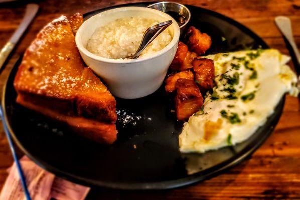 2021 - Stuffed French toast with apple cinnamon stuffing served with candied pork belly, two over medium eggs and grits