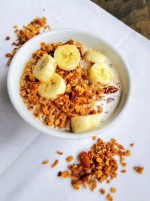 Housemade nut and seed granola, served with choice of milk and sliced banana.