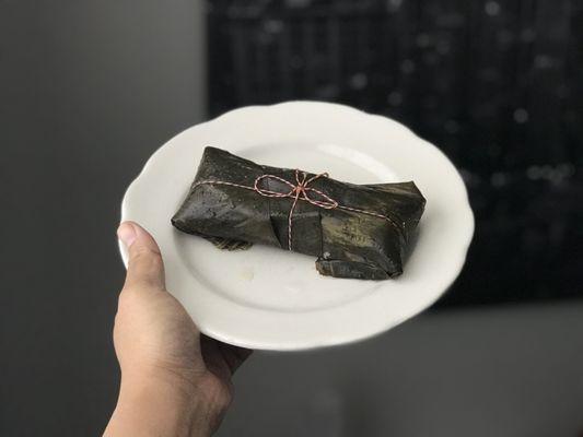 Tamale wrapped in banana leaves.