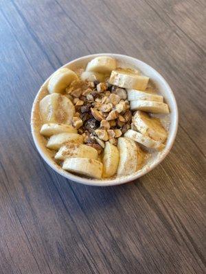 Oatmeal Bowl with oatmeal, cinnamon, almond milk, agave or honey. Topped with banana, raisins, and almonds.