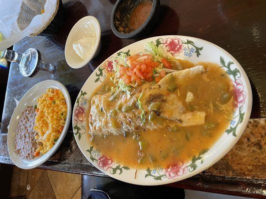 shredded beef burrito smothered in green chili no added cheese and a side of Mexican rice and beans