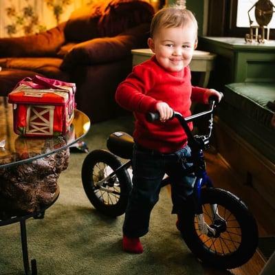 GREAT PHOTO !  Of a long time customer and friends child  receiving his first bike . Priceless