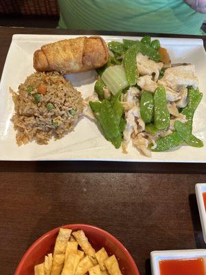 Chicken and snap peas lunch portion with fried rice and egg roll