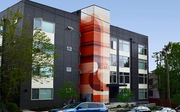 Exterior architectural panels covered in vibrant vinyl pattern.