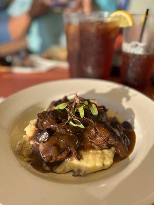 Beef tips over mashed potatoes.