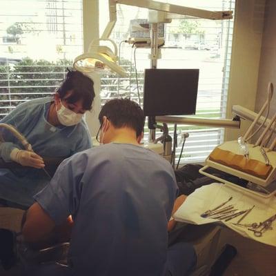 Dr. Yun and his assistant Karla improving the world one smile at a time.