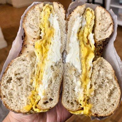 Egg and cheese with cream cheese on an everything bagel