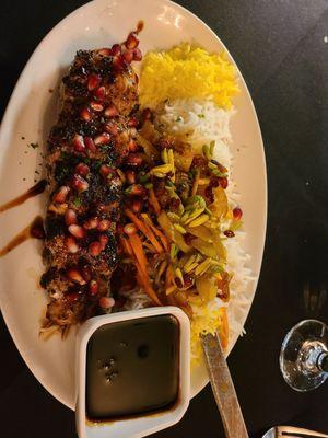 Persian chicken special, chicken breast stuffed with pomegranate seeds, nuts, and herbs, with jeweled rice.