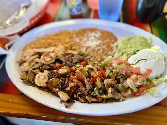 Mixed fajita with corn tortillas on side