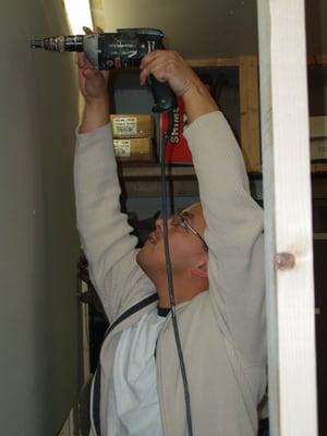 A member learns how to install drywall at a workshop