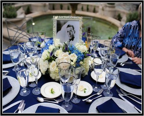 Wedding centerpieces with a Silver screen theme in blues and whites.