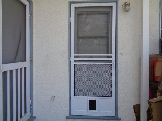 Colonial swinging hinged door with small pet door