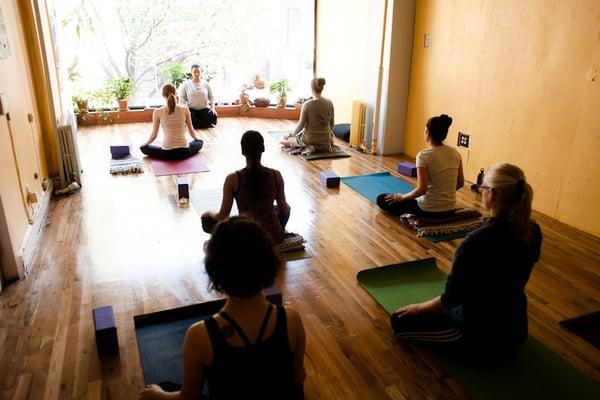 Students at our Clinton Hill yoga studio enjoy a peaceful moment at the beginning of class