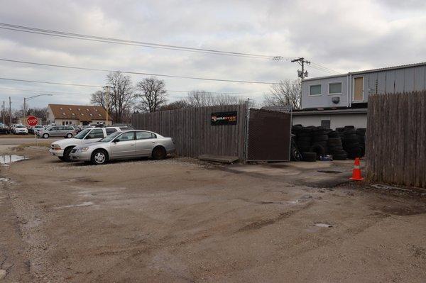 Back entrance of tire shop where you drive up to receive service, located on Atlantic Ave. This image was taken facing Green Bay Rd.