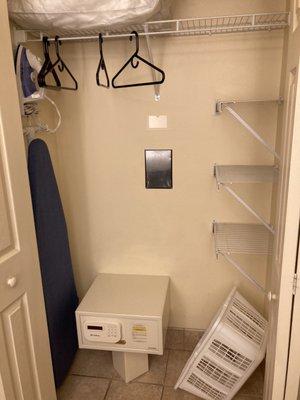 Closet with safe and ironing board and shelves