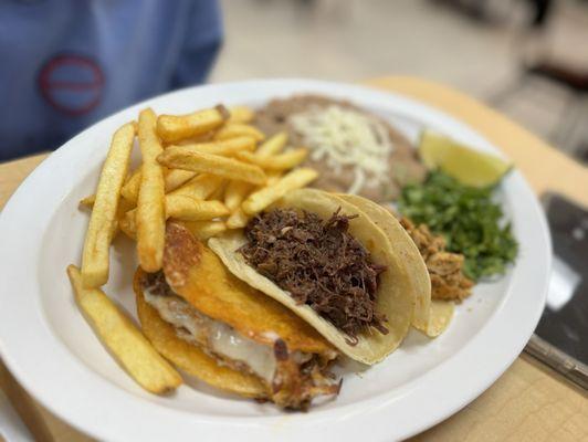 Choice of three tacos and side of French fries and refried beans