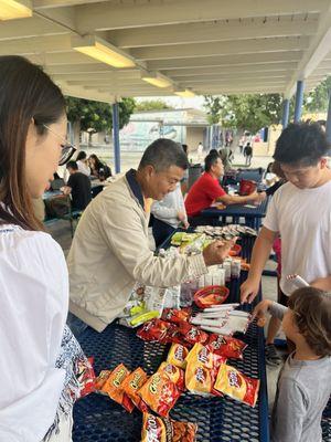 Parent volunteers selling snacks.