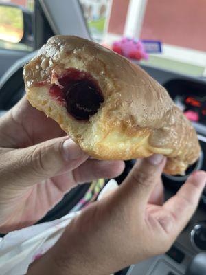 Maple glazed long John filled with raspberry