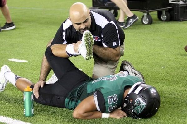 Dr Mo helping athletes on the sidelines.