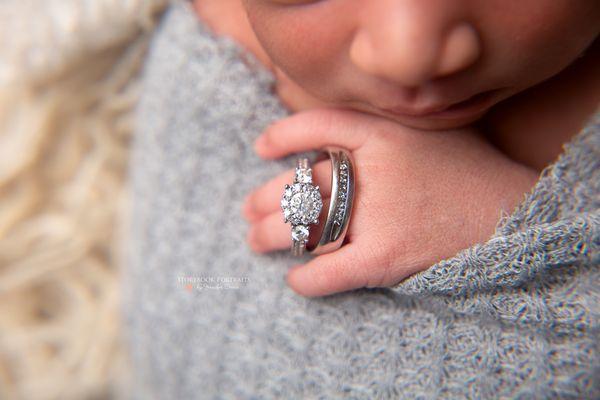 newborn photography "close up of newborn with wedding rings"